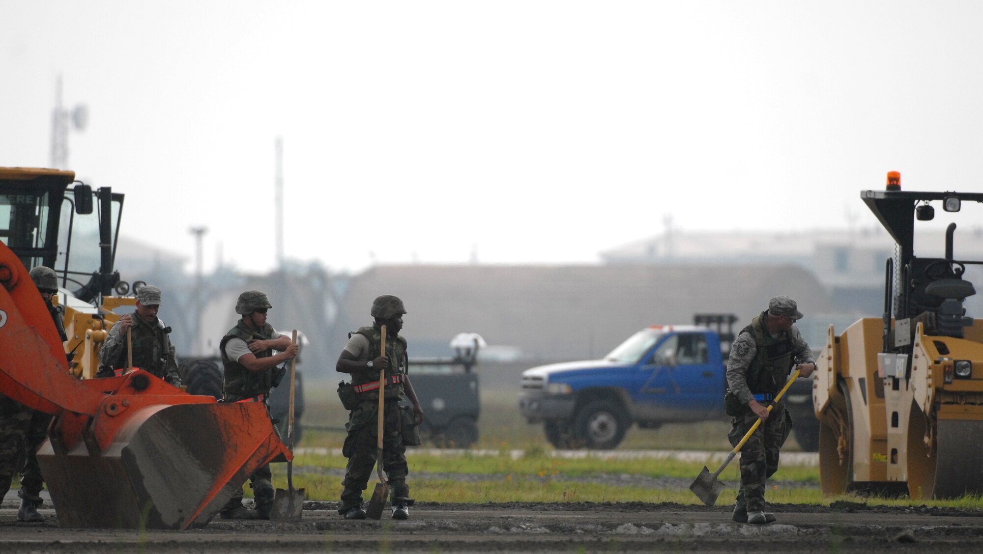 KUNSAN AIR BASE, Republic of Korea -- Members of the 8th Civil Engineer Squadron Rapid Runway Repair team work to restore the runway during a peninsula wide operational readiness exercise scenario here July 24.  Kunsan is participating the PENORE to evaluate the wing’s readiness and ability to perform its wartime mission.  (U.S. Air Force photo/TSgt Quinton T. Burris)
