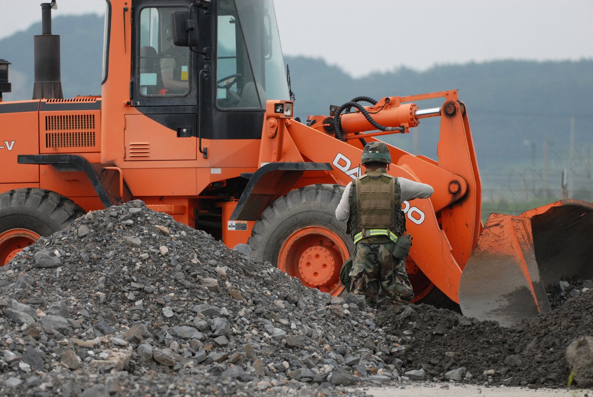 KUNSAN AIR BASE, Republic of Korea -- Members of the 8th Civil Engineer Squadron Rapid Runway Repair team work to restore the runway during a peninsula wide operational readiness exercise scenario here July 24.  Kunsan is participating the PENORE to evaluate the wing’s readiness and ability to perform its wartime mission.  (U.S. Air Force photo/TSgt Quinton T. Burris)