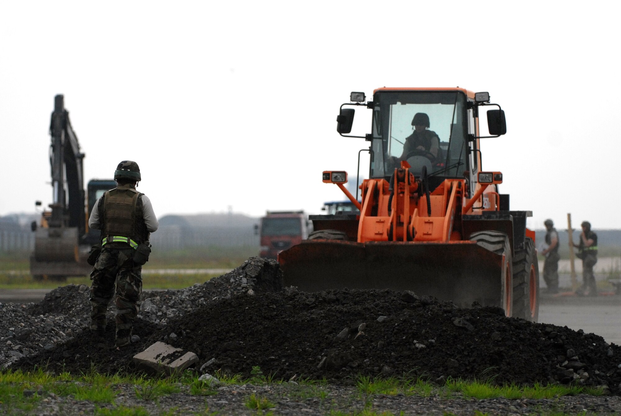 KUNSAN AIR BASE, Republic of Korea -- Members of the 8th Civil Engineer Squadron Rapid Runway Repair Team work to restore the runway during a peninsula wide operational readiness exercise scenario here July 24.  Kunsan is participating the PENORE to evaluate the wing’s readiness and ability to perform its wartime mission.  (U.S. Air Force photo/TSgt Quinton T. Burris)
