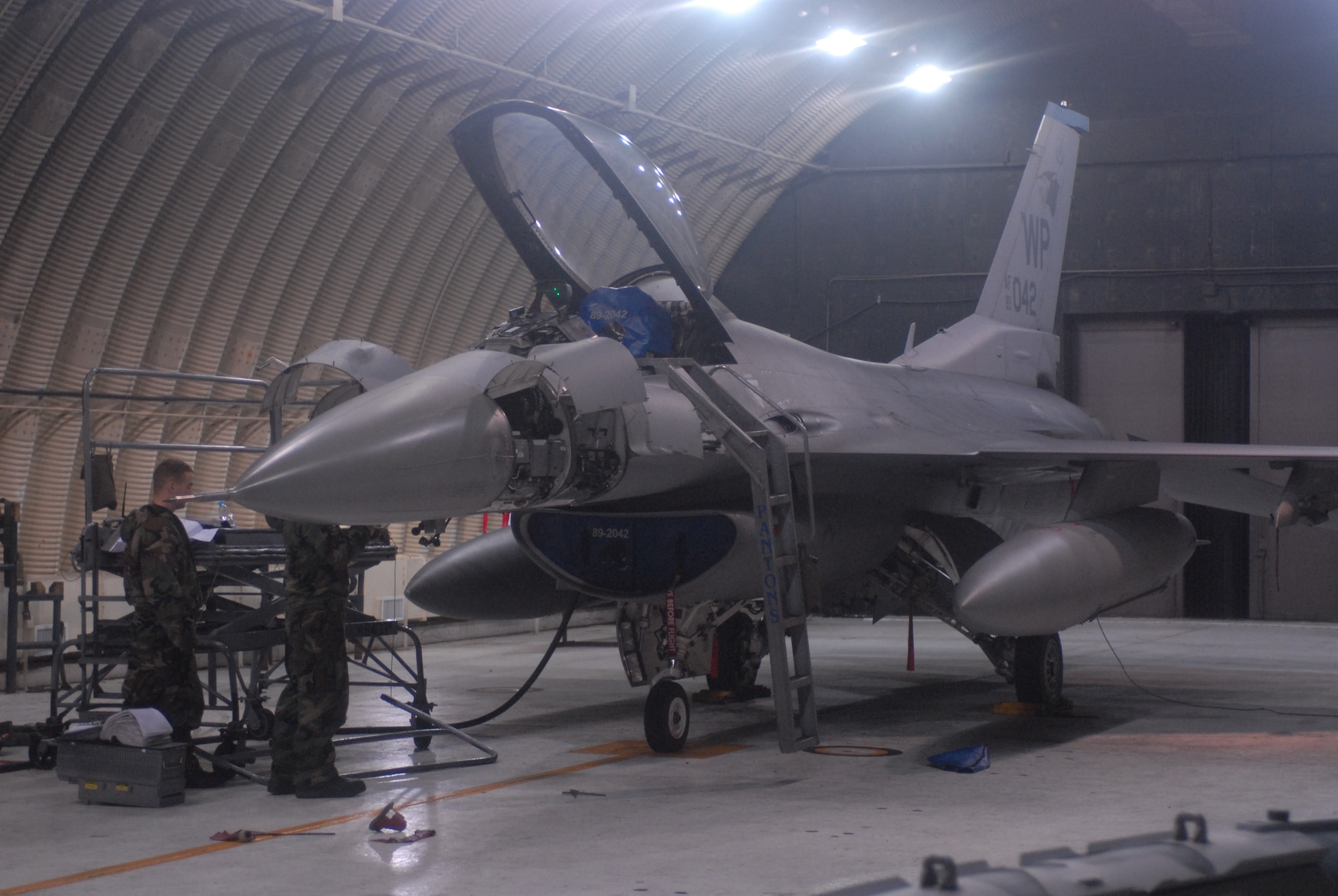 KUNSAN AIR BASE, Republic of Korea -- Staff Sgt. Daniel Egbert and Senior Airman Robert Watson, 35th Aircraft Maintenance Squadron, perform routine maintenance on an F-16 during the peninsula wide operational readiness exercise, July 24. Kunsan is participating in the PENORE to evaluate its readiness and ability to conduct its wartime mission. (U.S. Air Force photo/Senior Airman Gustavo Gonzalez)