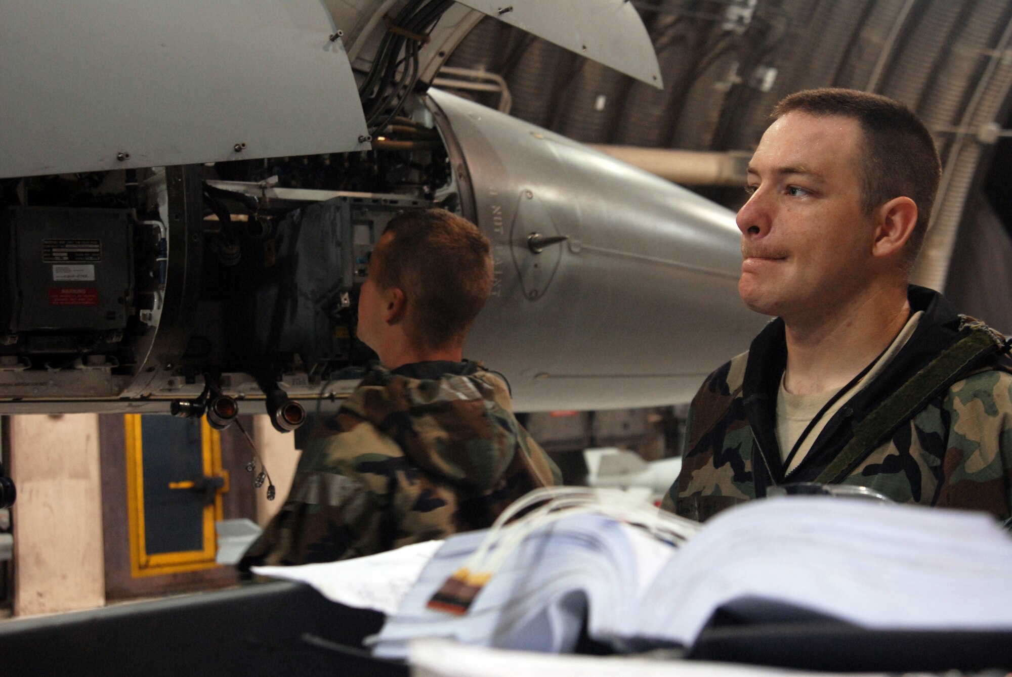 KUNSAN AIR BASE, Republic of Korea – Staff Sgt. Daniel Egbert (right) observes Senior Airman Robert Watson, perform routine maintenance during the BEVERLY BULLDOG 08-03 peninsula wide operational readiness exercise here July 24. Both Airmen are F-16 Avionics technicians assigned to the 8th Aircraft Maintenance Squadron. Kunsan is participating in the PENORE to evaluate its readiness and ability to perform its wartime mission. (U.S. Air Force photo/Staff Sgt. Jason Colbert)