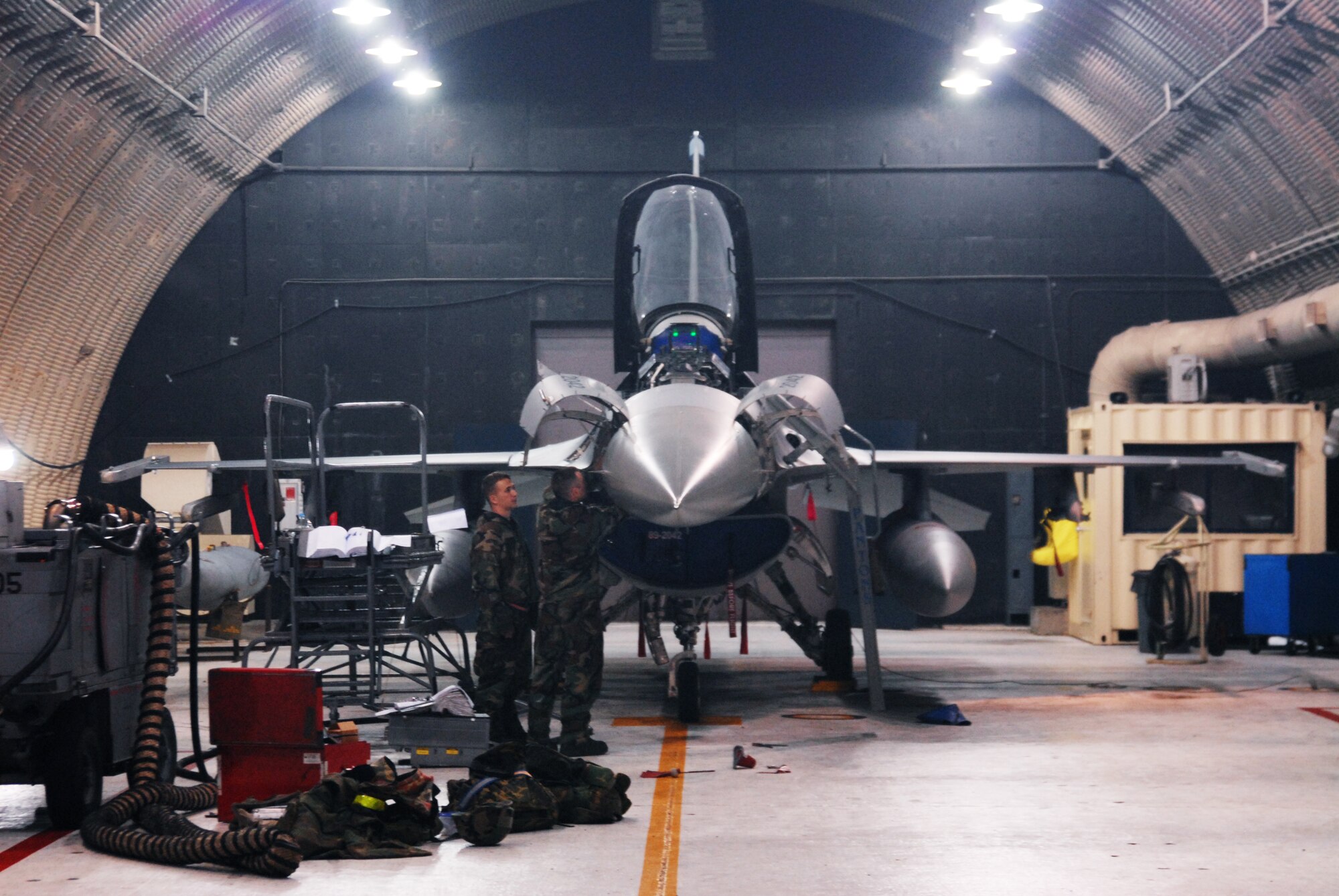 KUNSAN AIR BASE, Republic of Korea -- Two F-16 Avionics technicians assigned to the 35th Aircraft Maintenance Squadron perform routine maintenance during the BEVERLY BULLDOG 08-03 peninsula wide operational readiness exercise here July 24. Kunsan is participating in the PENORE to evaluate its readiness and ability to perform its wartime mission. (U.S. Air Force photo/Staff Sgt. Jason Colbert)