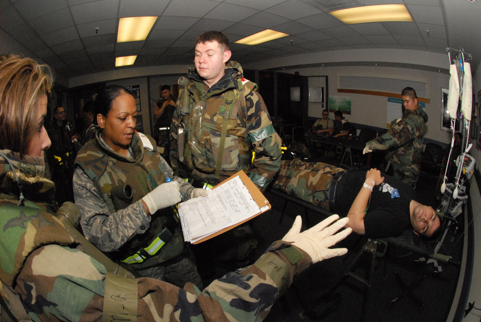 KUNSAN AIR BASE, Republic of Korea -- Capt. Lynne Smith, 8th Medical Group nurse, directs 8th Medical Group personnel in the care of a wounded "Wolfpack" member during the BEVERLY BULLDOG 08-03 peninsula wide operational readiness exercise here July 23. Kunsan is participating in the PENORE to evaluate its readiness and ability to perform its wartime mission. (U.S. Air Force photo/Staff Sgt. Jason Colbert)