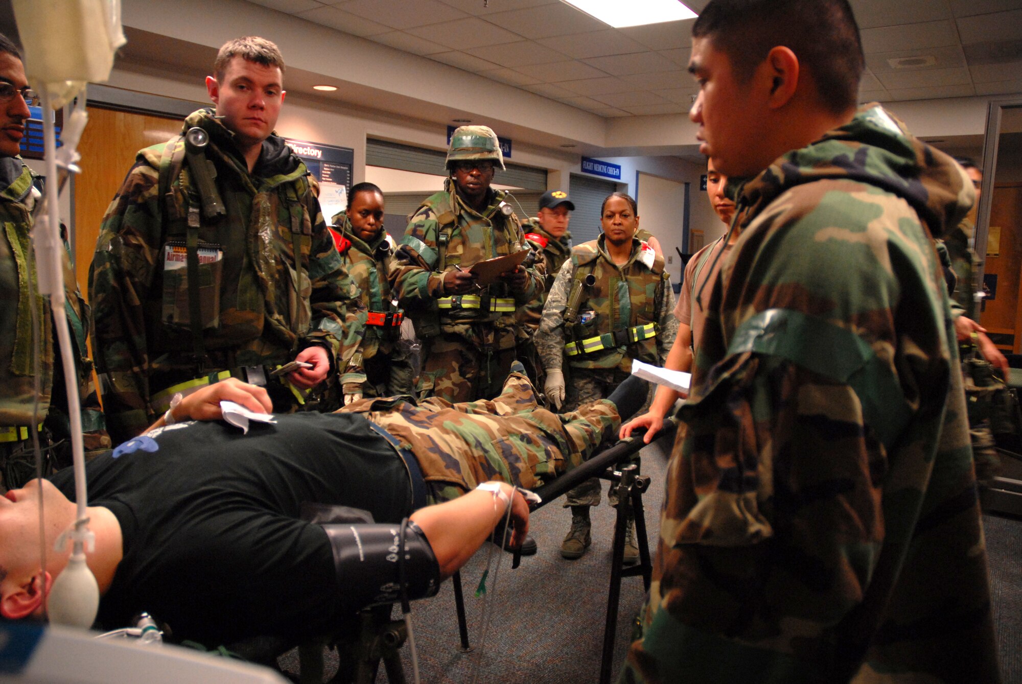 KUNSAN AIR BASE, Republic of Korea -- 8th Medical Group personnel gather to administer medical assistance to a wounded "Wolfpack" member during the BEVERLY BULLDOG 08-03 peninsula wide operational readiness exercise here July 23. Kunsan is participating in the PENORE to evaluate its readiness and ability to perform its wartime mission. (U.S. Air Force photo/Staff Sgt. Jason Colbert)