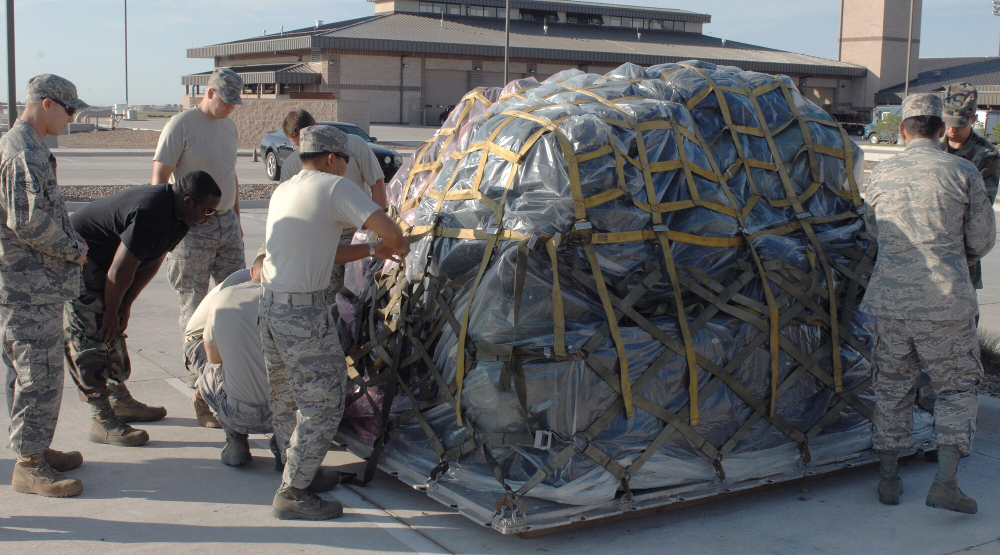 CANNON AIR FORCE BASE N.M.-- Airman from the 1st Special Operation Communication Squadron, 27th Special Operations Logistics Readiness Squadron, and the 280th Combat Controllers inspect a flight transportation pallet July 24.  Airman from several bases partcipated in the Joint Lightning exercise and then prepared to return to their home station.  (U.S. Air Force photo by Airman 1st Class James R. Bell)