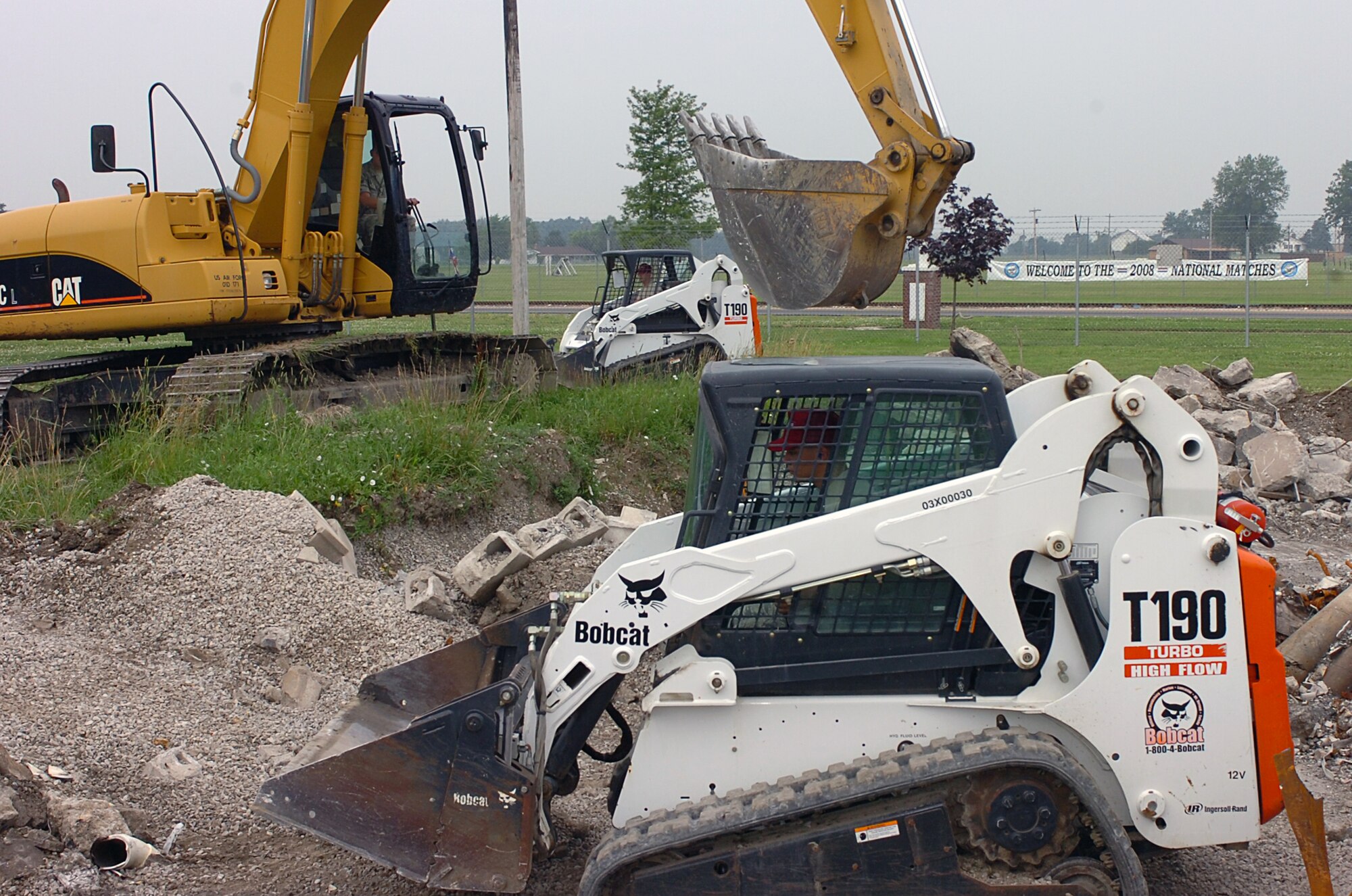 Airmen from the Ohio Air National Guard's 200th RED HORSE squadron at Port
Clinton, Ohio, operate heavy equipment July 19 to demolish a barracks
foundation. The squadron recently activated a new 200-person detachment at
Mansfield Air Guard Base, about one hour's drive south.  RED HORSE squadrons
are manned by civil engineers who can build and repair air bases and rapidly
deploy to recover an air base after a natural disaster or enemy attack.
(Photo by Master Sgt. Mike R. Smith, National Guard Bureau)