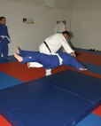 7/23/2008 - David Mata, Wilford Hall Hemodialysis Unit supervisor and instructor with the Lackland Air Force Judo Club, practices take down techniques with Connie Kellen, a summer intern at the 67th Network Warfare Wing, on Wednesday. The Judo club meets every Monday and Wednesday at 4:30 p.m. (USAF photo by Alan Boedeker)                               