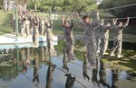 7/17/2008 - Trainees from basic military training negotiate a water obstacle at the basic military training obstacle course July 17.  Changes were made to the basic military training curriculum in November 2005 that focuses more on instilling war skills and strengthening the warrior ethos in Airmen graduating from training.  BMT is scheduled to lenghen by two weeks later this year.  (USAF photo by Alan Boedeker)