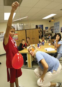 7/14/2008 - Kathy Martin explains the properties of air to students attending the Starbase Kelly academy at the 433rd Airlift Wing at Lackland Air Force Base while Alexander McKee assists with the demonstration July 14.  The demonstration was among several activities Starbase Kelly participants experienced during the weeklong summer camp. (USAF photo by Robbin Cresswell)