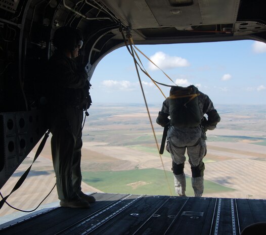 An 819th RED HORSE Squadron Airman steps off the back of a Montana Army National Guard Chinook helicopter during the squadron’s airborne team jump training at Malmstrom  Air Force Base July 23. Roughly 11 members of the 819th RHS participated in the jump which helps the airborne team meet quarterly training requirements.  (U.S. Air Force photo/Senior Airman Eydie Sakura)