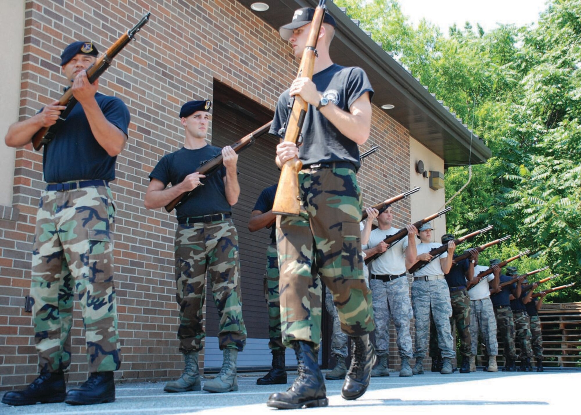 Airman 1st Class Timothy F. Poole, instructor for the Honor Guard training course and carpentry apprentice with the 316th Civil Engineer Squadron, inspects demilitarized M1 rifle positioning during training for new Honor Guard members here.   	
