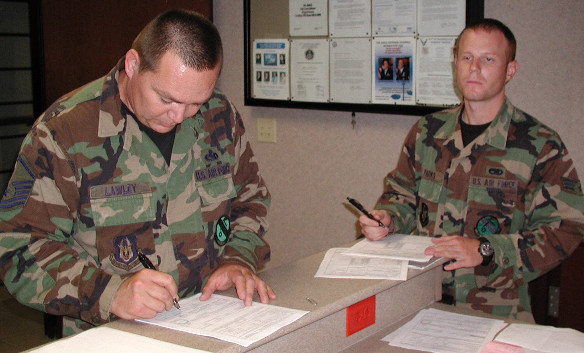 Master Sgt. Brian Lawley (left) and Senior Airman Neil Parks fill out paperwork after returning from a deployment to Turkey.  Sergeant Lawley is the jet section lead for the 931st Aircraft Maintenance Squadron and Airman Parks is an aircraft hydraulic systems journeyman for the squadron. (U.S. Air Force photo/Tech. Sgt. Ed Cropper)