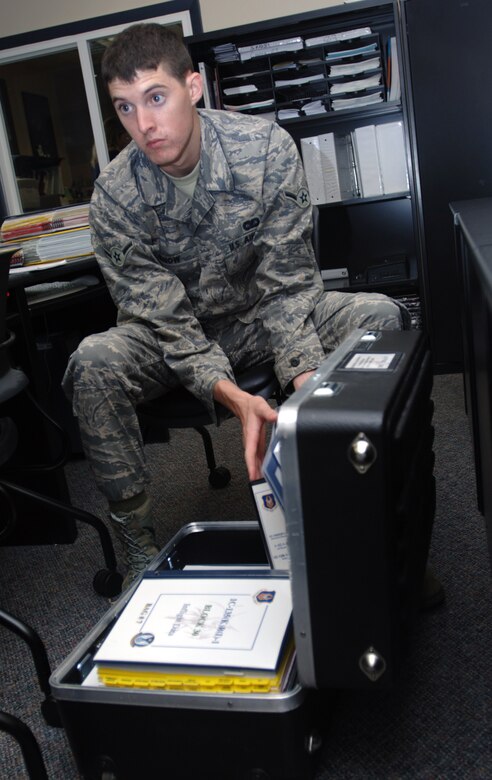 Airman 1st Class Elliott Snow removes binders from a case while learning how to put together technical orders for KC-135 aircrews assigned to the 931st Air Refueling Squadron.  The training was funded by an Air Force Reserve program designed to make traditional Reservists functional in their specialties at a faster rate. (U.S. Air Force photo/Tech. Sgt. Jason Schaap)
