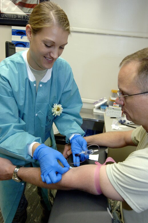 LANGLEY AIR FORCE BASE, Va. -- Staff Sgt. Amanda Mikesh, the non-commissioned officer in charge of laboratory customer service at 1st Fighter Wing Hospital, draws blood from Chief Master Sgt. Larry Petrie,  Air Combat Command Directorate of Communications functional manager, July 15.  Phlebotomy is one of many duties performed by lab technicians. (U.S. Air Force photo/Airman 1st Class Sylvia Olson)