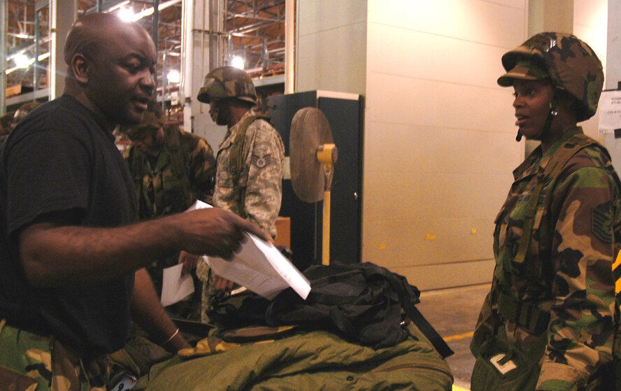 Servicemembers check and sign off on an inventory list given out with their mobility bags as a simulated practice for an upcoming Operational Readiness Inspection (ORI) for the 94th Airlift Wing here. (U.S. Air Force photo taken by Airman Chelsea A. Gitzen)