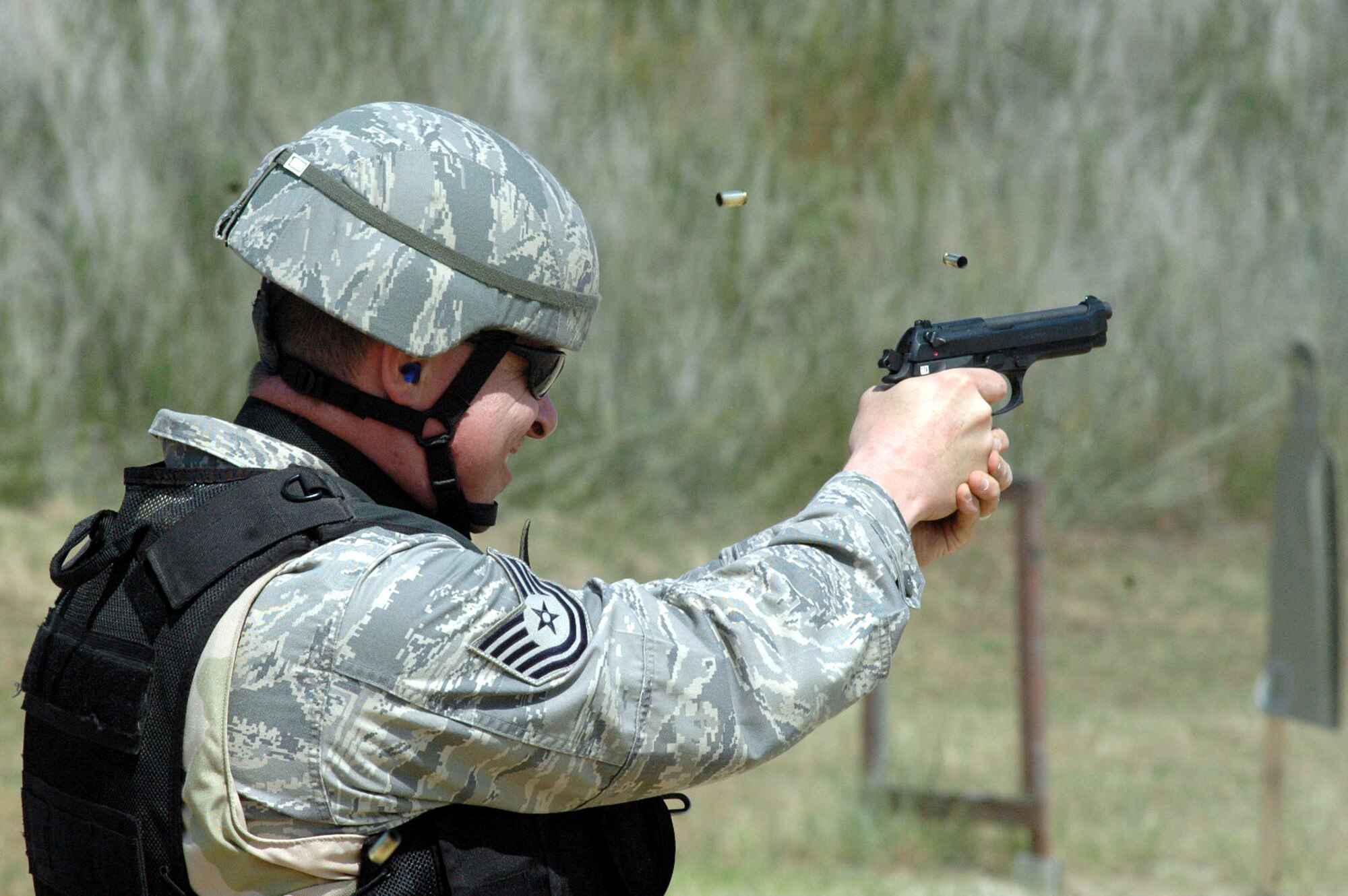A student in the Air Force Phoenix Warrior Training Course takes aim at a target with a 9mm pistol during live tactical firing training on a Fort Dix, N.J., range June 20, 2008.  Phoenix Warrior is a security forces pre-deployment course offered by the U.S. Air Force Expeditionary Center and is taught by the 421st Combat Training Squadron.  (U.S. Air Force Photo/Tech. Sgt. Scott T. Sturkol)