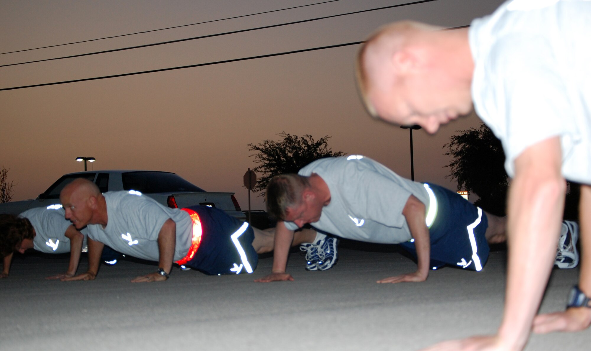 LAGUHLIN AIR FORCE BASE, Texas -- Members of Laughlin’s senior non-commissioned officers perform warm-up push ups before their run here July 18.  The 5-k Senior NCO Run, organized by Laughlin enlisted leadership to build teamwork and espirit de corps among members, takes place once a quarter.  (U.S. Air Force photo/Staff Sgt. Olufemi Owolabi)     