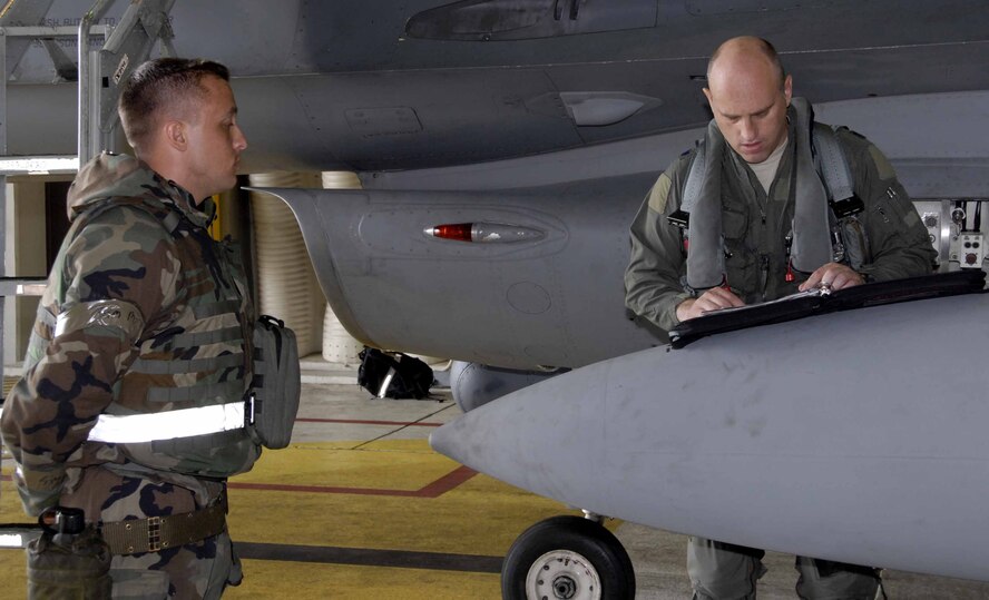 OSAN AIR BASE, Republic of Korea – Lt. Col. Jon "Lurch" Wilkinson, 36th Fighter Squadron operations officer, performs a pre-flight inspection with Senior Airman Bryan Strole, 51st Maintenance Squadron tactical aircraft maintainer, during a base wide exercise here July 23. (U.S. Air Force photo/Staff Sgt. Lakisha Croley)