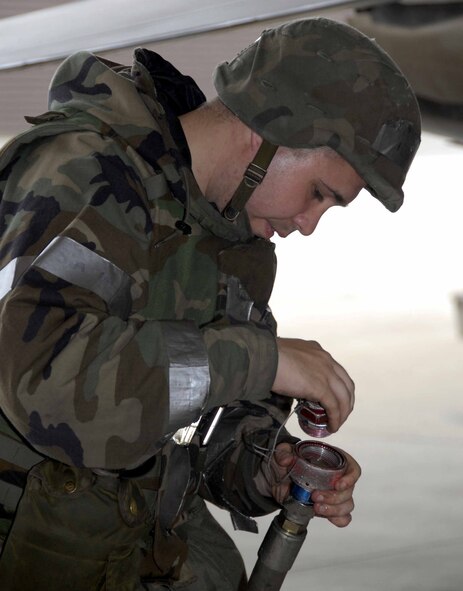 OSAN AIR BASE, Republic of Korea -- Staff Sgt. Kenneth Dickey, F-16 avionics craftsman, rolls up a "mule" as he performs maintenance clean up during a base-wide exercise here July 23. (U.S. Air Force photo/Staff Sgt. Lakisha Croley)