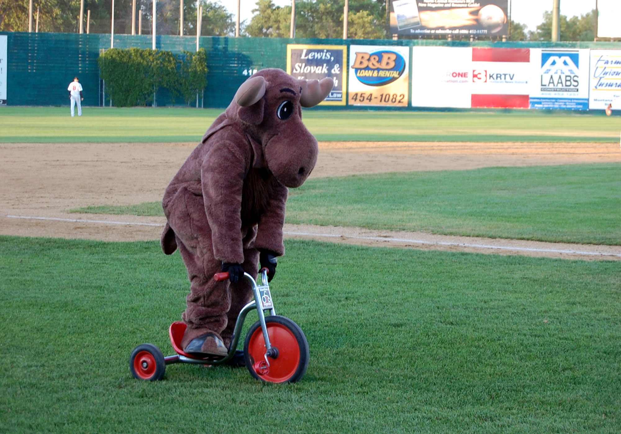 Mel the Moose, 341st Services Squadron mascot, races a tricycle during Military Appreciation Night at Centene Stadium July 18. (U.S. Air Force photo/Airman 1st Class Dillon White)