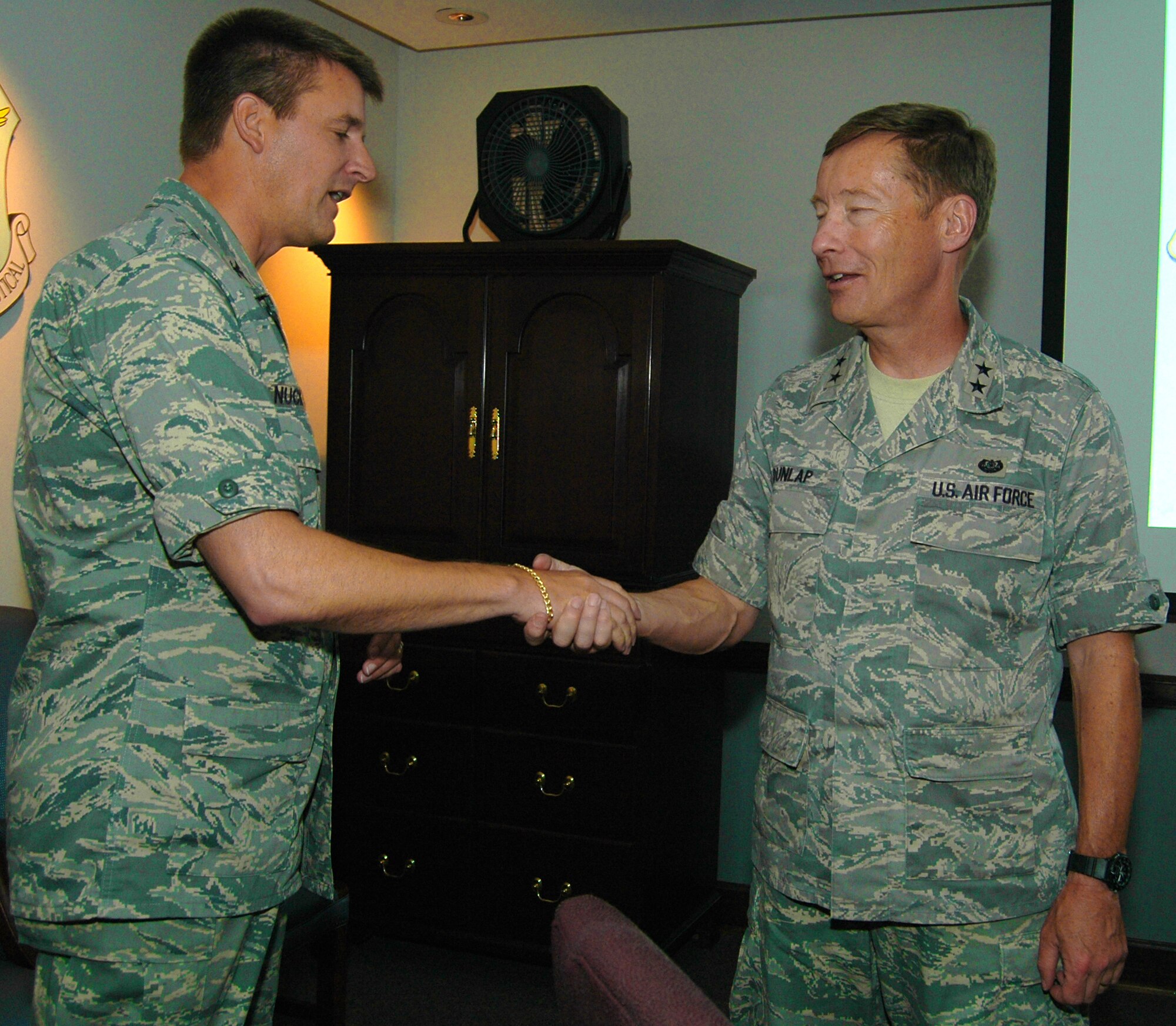 Colonel Heath J. Nuckolls, the 94th Airlift Wing commander here, presents Maj. Gen. Charles J. Dunlap Jr., the Deputy Judge Advocate General of the USAF, with an honorary wing coin as Col. Nuckolls welcomes Maj. Gen. Dunlap to the wing as he inspects the status of the legal department of the wing. (U.S. Air Force photo taken by Airman Chelsea A. Gitzen)