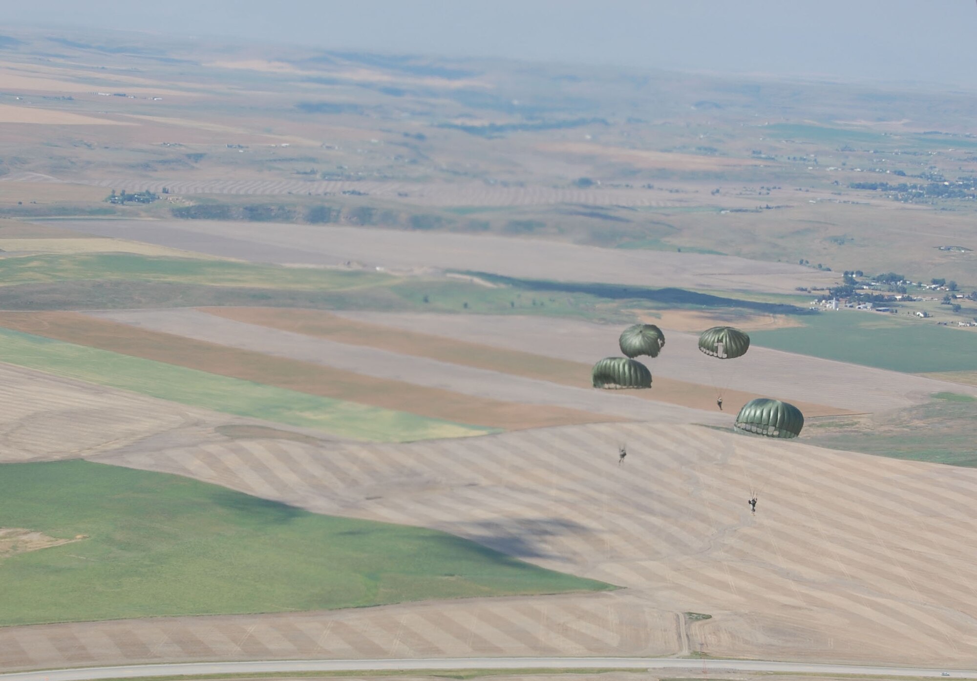 Four members of the 819th RED HORSE Squadron airborne team participate in jump training at Malmstrom Air Force Base July 23.  Roughly 11 Airmen participated in the quarterly training requirement with the assistance of the Montana Army National Guard and their Chinook helicopter.  (U.S. Air Force photo/Senior Airman Eydie Sakura)