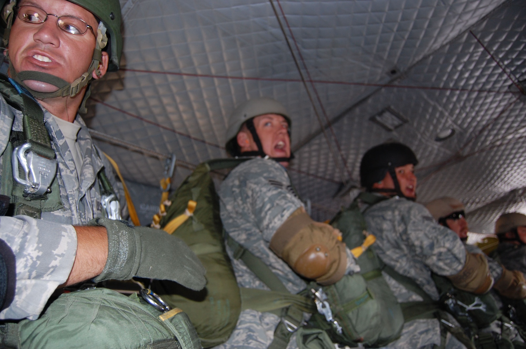 Members of the 819th RED HORSE Squadron airborne team performed jump training at Malmstrom Air Force Base with aerial assistance from the Montana Army National Guard and their Chinook helicopter July 23. Team members receive orders from the front on when to jump and each Airman is responsible for communicating the information to the back of the line. The parachutes weigh about 40 pounds each and their backpacks and gear weigh between 60 to 75 pounds. (U.S. Air Force photo/Senior Airman Eydie Sakura)