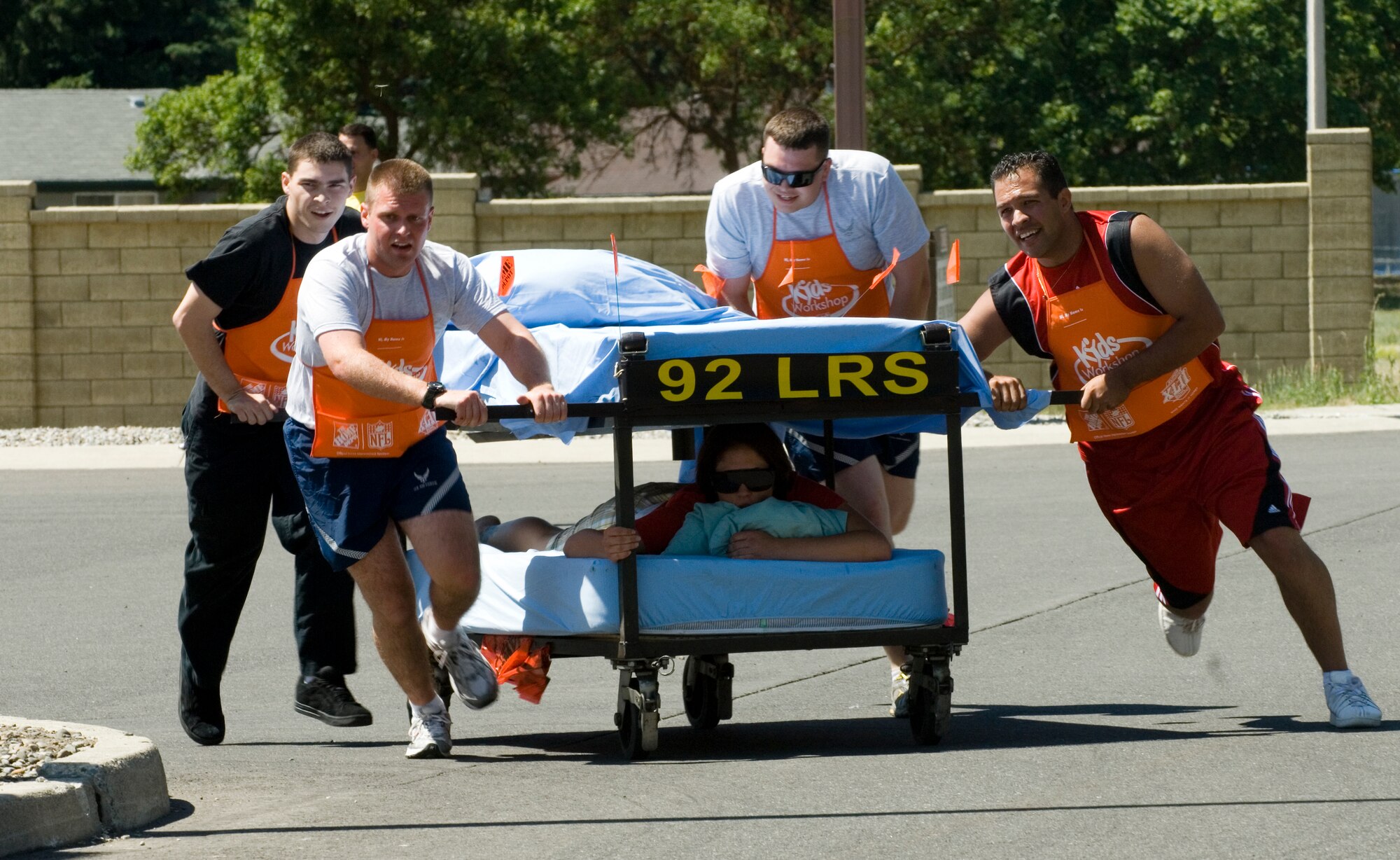 FAIRCHILD AIR FORCE BASE, Wash. – 92nd Logistics Readiness Squadron team members jolt during the last stretch of the Bed Race event at Miller Park during the annual wing picnic July 18. The 92nd LRS won the award for most spirited team during the event. (U.S. Air Force photo / Airman 1st Class Joshua Chapman)