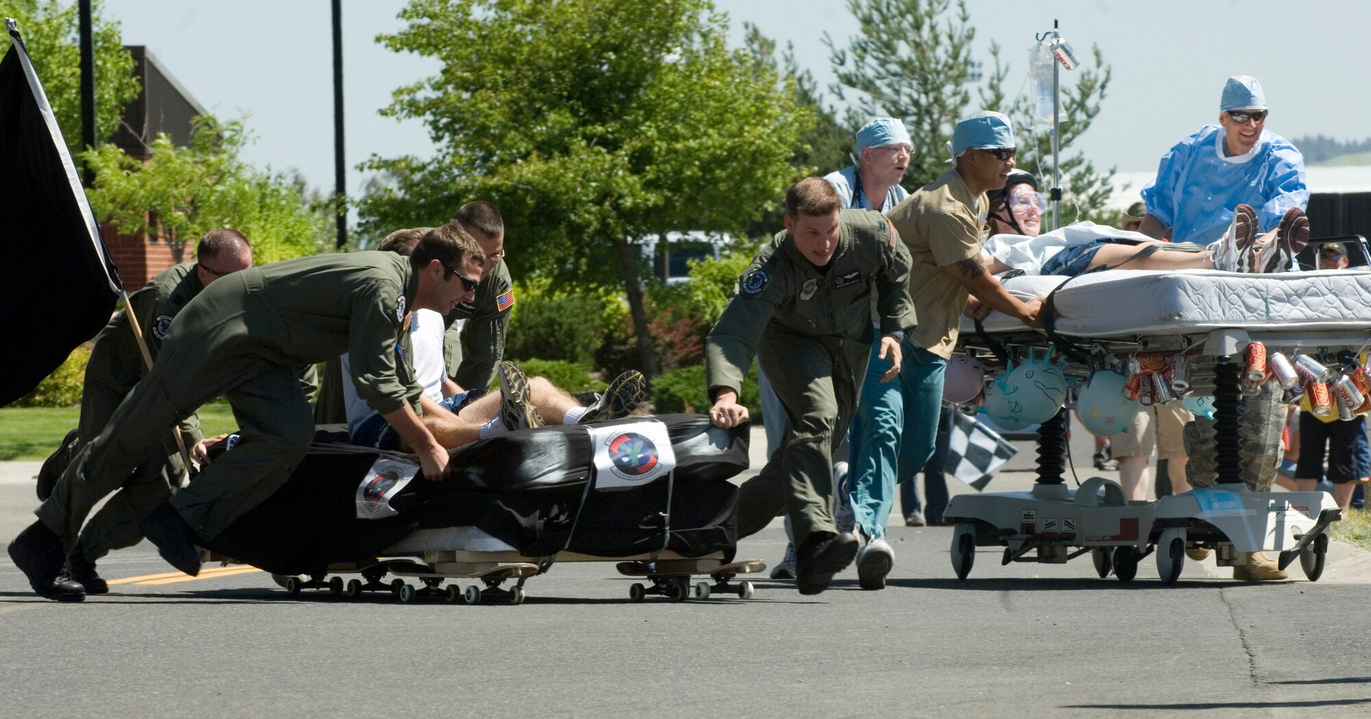 FAIRCHILD AIR FORCE BASE, Wash. – Teams from the 93rd Air Refueling Squadron and the 92nd Medical Group quickly maneuver their mobile sleepers around a corner during the Bed Race event at the annual wing picnic here July 18. Participants in the bed race strode their handcrafted beds throughout an obstacle course. The 92nd Services Squadron was victorious in the overall event. (U.S. Air Force photo / Airman 1st Class Joshua Chapman)