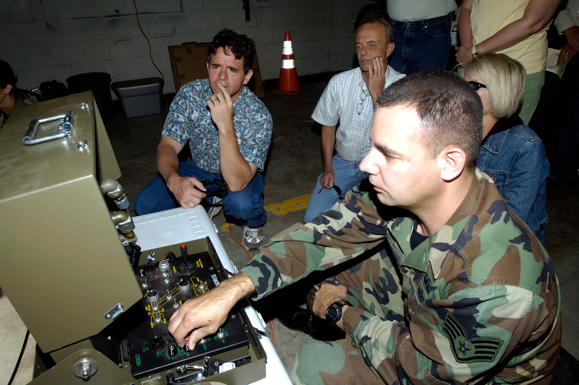FAIRCHILD AIR FORCE BASE, Wash. – Staff Sgt. Chris Adjoodani, 92nd Civil Engineer Squadron, demonstrates the use of remote controls on explosive ordinance robots during a honorary commander’s tour on base July 19. The honorary commanders toured several of the 92nd Mission Support Group agencies throughout the day.  (U.S. Air Force photo / Senior Airman Eunique Stevens)