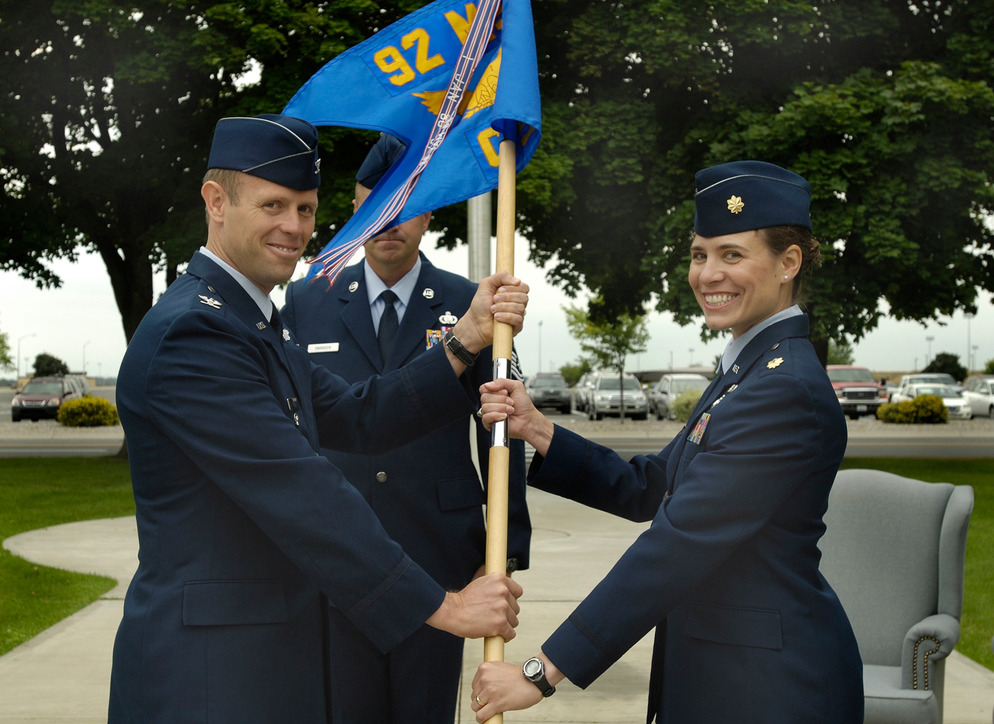FAIRCHILD AIR FORCE BASE, Wash. -- Col. Blaine Holt, 92nd Air Refueling Wing vice commander, presents Maj. Melissa Cunningham, 92nd Communications Squadron commander, with the Squadron guideon during the 92nd CS change-of-command ceremony here July 22. (U.S. Air Force photo / Senior Airman Eunique Stevens)