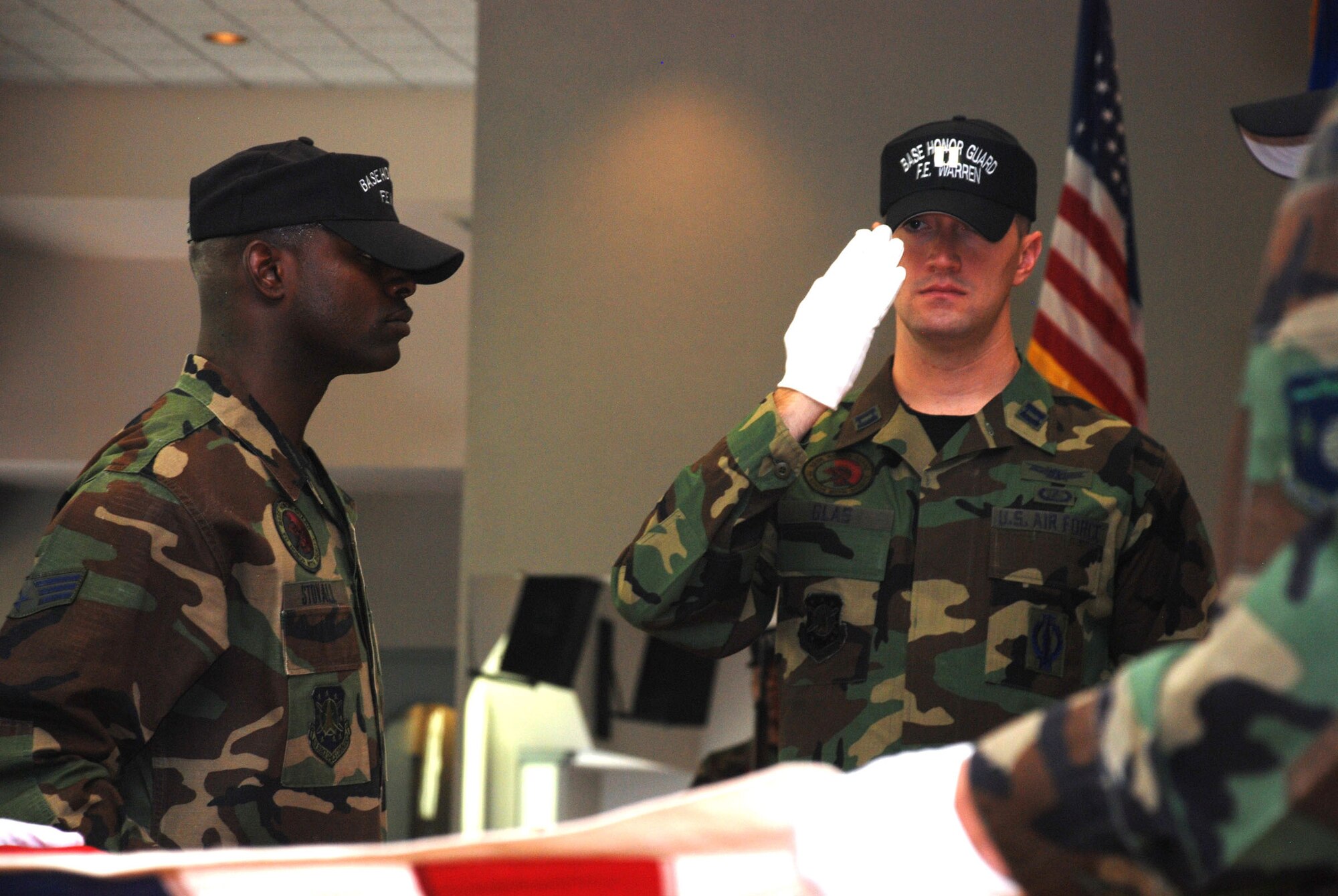 Capt. Robert Glas, F.E. Warren honor guard member, salutes the flag during a demonstration funeral performed following graduation from a mobile training class held at F.E. Warren July 16. (U.S. Air Force photo/Airman 1st Class Daryl Knee) 