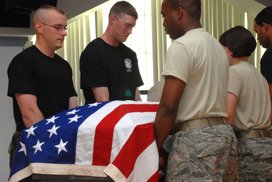 Honor Guard members from F.E. Warren AFB, Wyo., Malmstrom AFB, Mont., and the United States Air Force Academy, Colo., practice pall bearing movements during a mobile training course taught by United States Air Force honor guard instructors from Bolling Air Force Base, Washington, D.C. (U.S. Air Force photo/Airman 1st Class Daryl Knee)