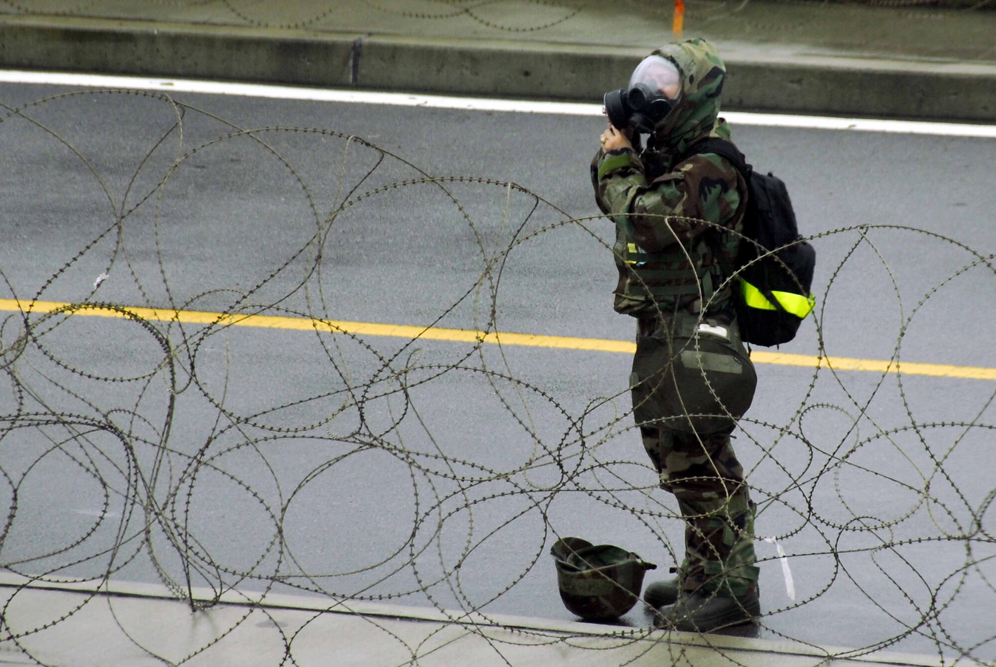 OSAN AIR BASE, Republic of Korea -- An Airman dons her MOPP gear during a base-wide exercise here July 24. The operational readiness exercise tests Team Osan's ability to execute combat operations, receive follow-on forces and defend the base from attack. (U.S. Air Force photo/Senior Airman Christopher Boitz)