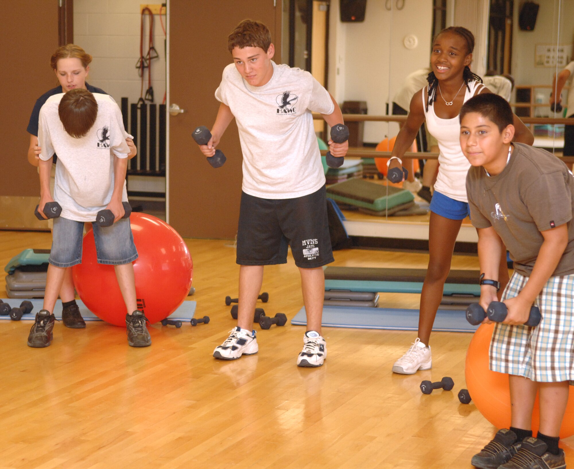 Teenagers enrolled in the Teen Wellness and Fitness Camp lift weights during a body sculpting class at the Fitness and Sports Center at Holloman Air Force Base, N.M., July 23. The two-day camp taught the teens many things such as nutrition, eating disorders, alcohol and drug awareness, safe dating and healthy living. The camp was designed to help them understand the fundamentals of fitness, proper eating and a healthy lifestyle. (U.S. Air Force photo/Airman Sondra M. Wieseler)