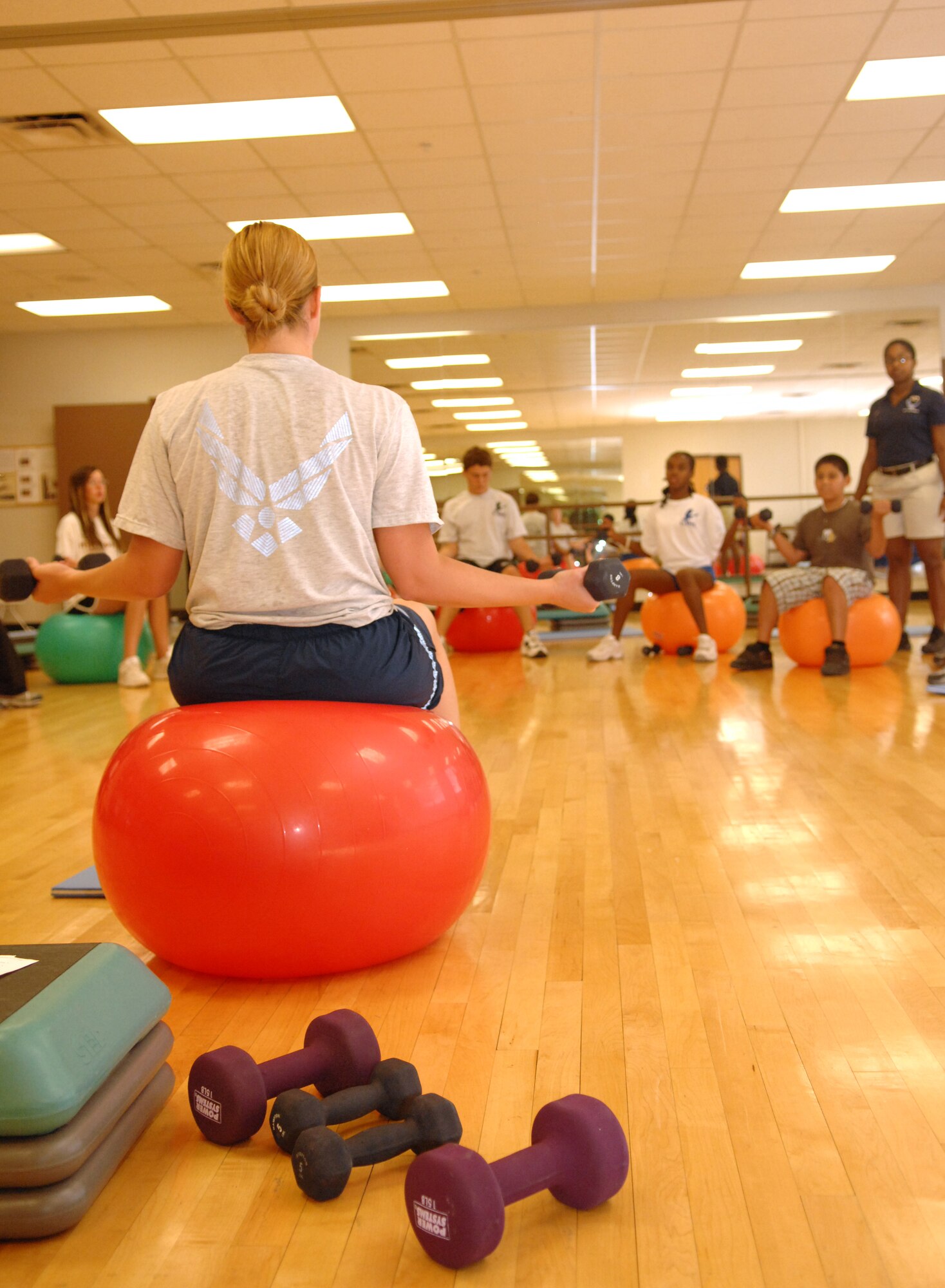 Tech. Sgt. Joya Stotz, 49th Force Support Squadron, leads a body sculpting class in lifting weights at the Fitness and Sports Center at Holloman Air Force Base, N.M., July 23. The class was made up of teenagers enrolled in the Teen Wellness and Fitness Camp who also learned about nutrition, eating disorders, and alcohol and drug awareness among many other things. (U.S. Air Force photo/Airman Sondra M. Wieseler)