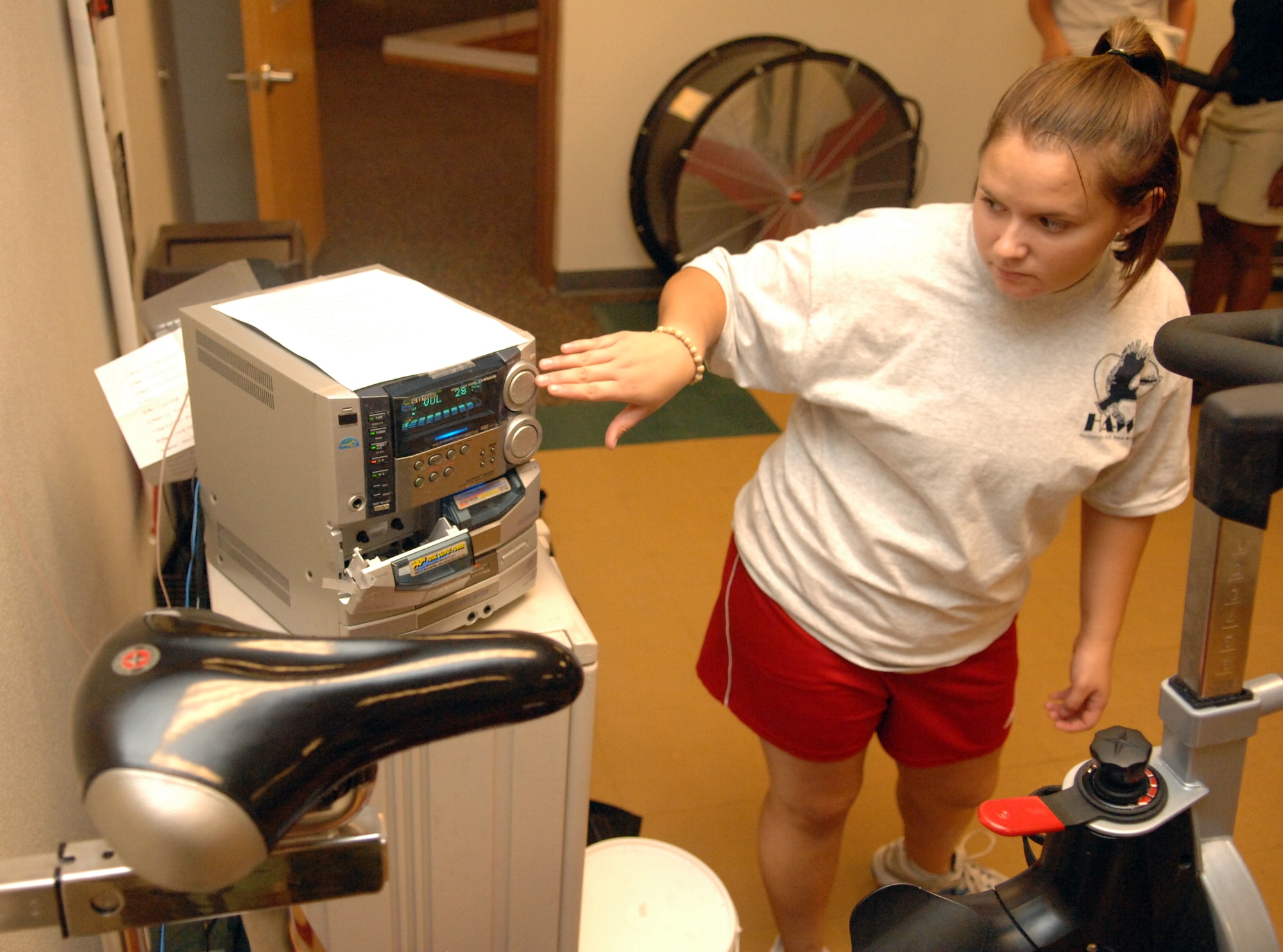 Airman 1st Class Amanda Morgan, 49th Force Support Squadron, turns up the music in the spinning room of the Fitness and Sports Center at Holloman Air Force Base, N.M., July 21. Airman Morgan played music while she instructed a group of teenagers in spin class as a part of the two-day Teen Wellness and Fitness Camp. (U.S. Air Force photo/Airman Sondra M. Wieseler)
