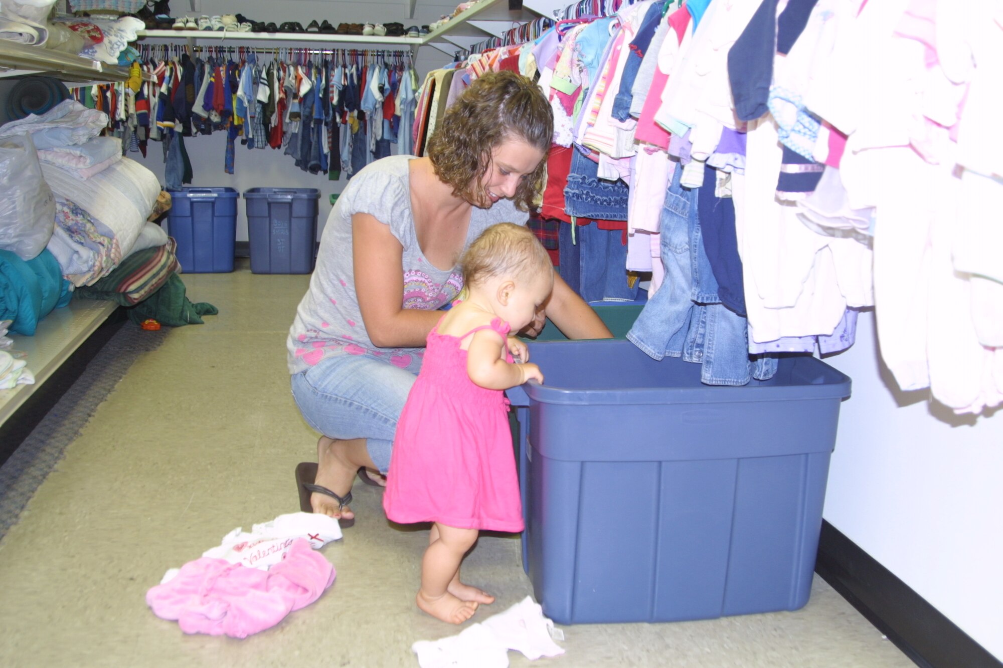 Britney Barlow and her daughter Jailyn, 11 months, look through baby clothing items at the Airmen’s Attic Monday. The Airmen’s Attic is open Mondays, Wednesdays and Fridays from 10 a.m. to 2 p.m. (U.S. Air Force Photo by Emily Smith)
