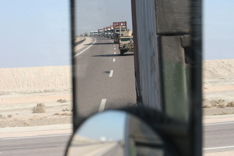 A line haul convoy is shown in this picture taken from a mirror’s view by Sergeant Callaway during one of her past deployments. (U.S. Air Force Photo by Tech. Sgt. Cynthia Callaway)