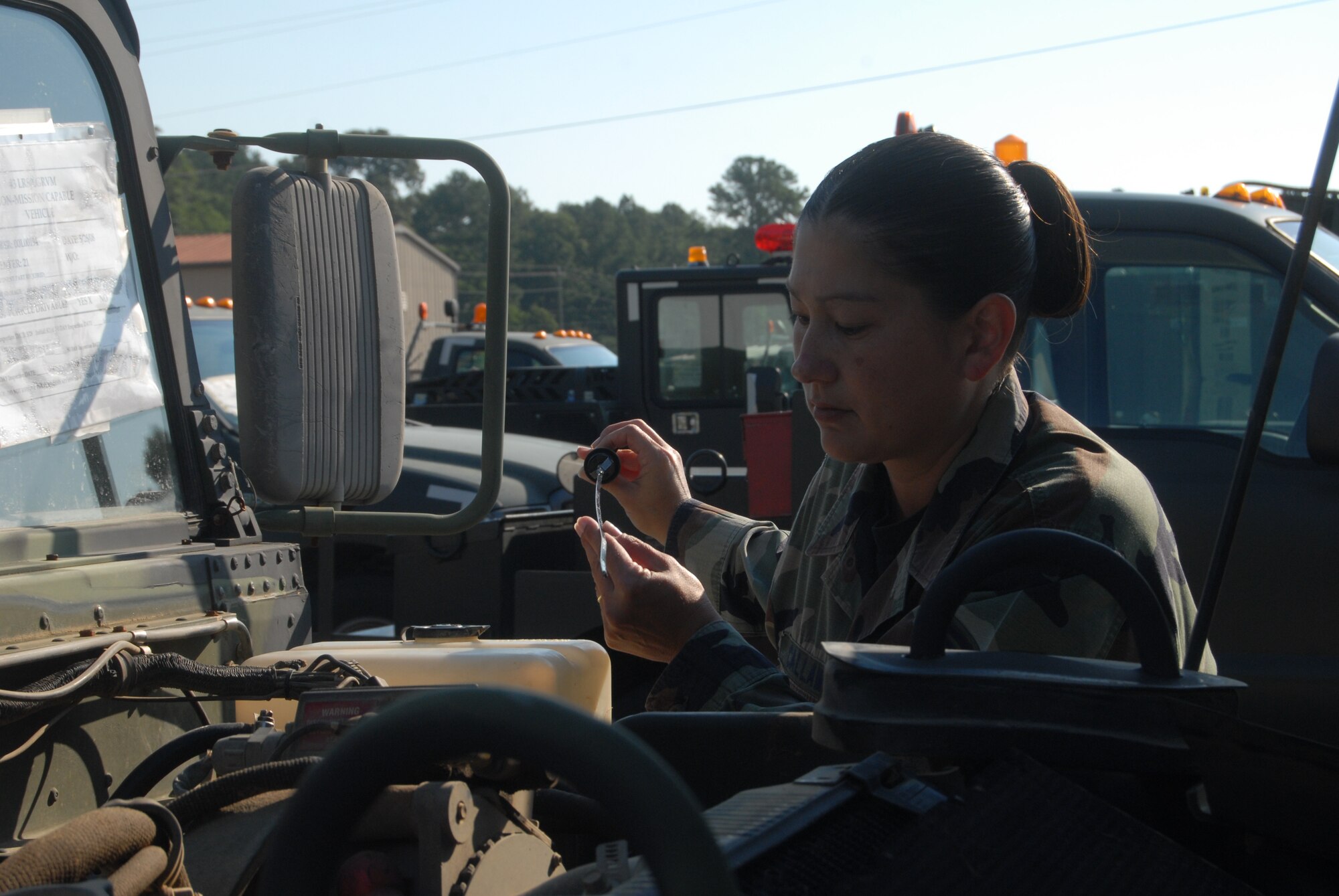 Tech. Sgt. Cynthia Callaway, 43rd Logistics Readiness Squadron, demonstrates the inspection process vehicle operators must go through before taking a vehicle out on the road. It is important for them to carefully inspect their vehicles beforehand to avoid breaking down while transporting valuable equipment. (U.S. Air Force Photo by Airman 1st Class Mindy Bloem)