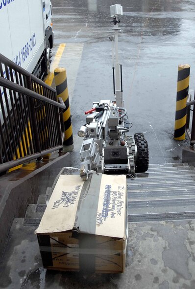 OSAN AIR BASE, Republic of Korea -- The F6A robot, used by the 51st Civil Engineer Squadron, Explosive Ordinance Disposal flight, removes a suspicious package from the base post office during a base-wide exercise here July 24, 2008. (U.S. Air Force photo/Staff Sgt. Lakisha Croley)