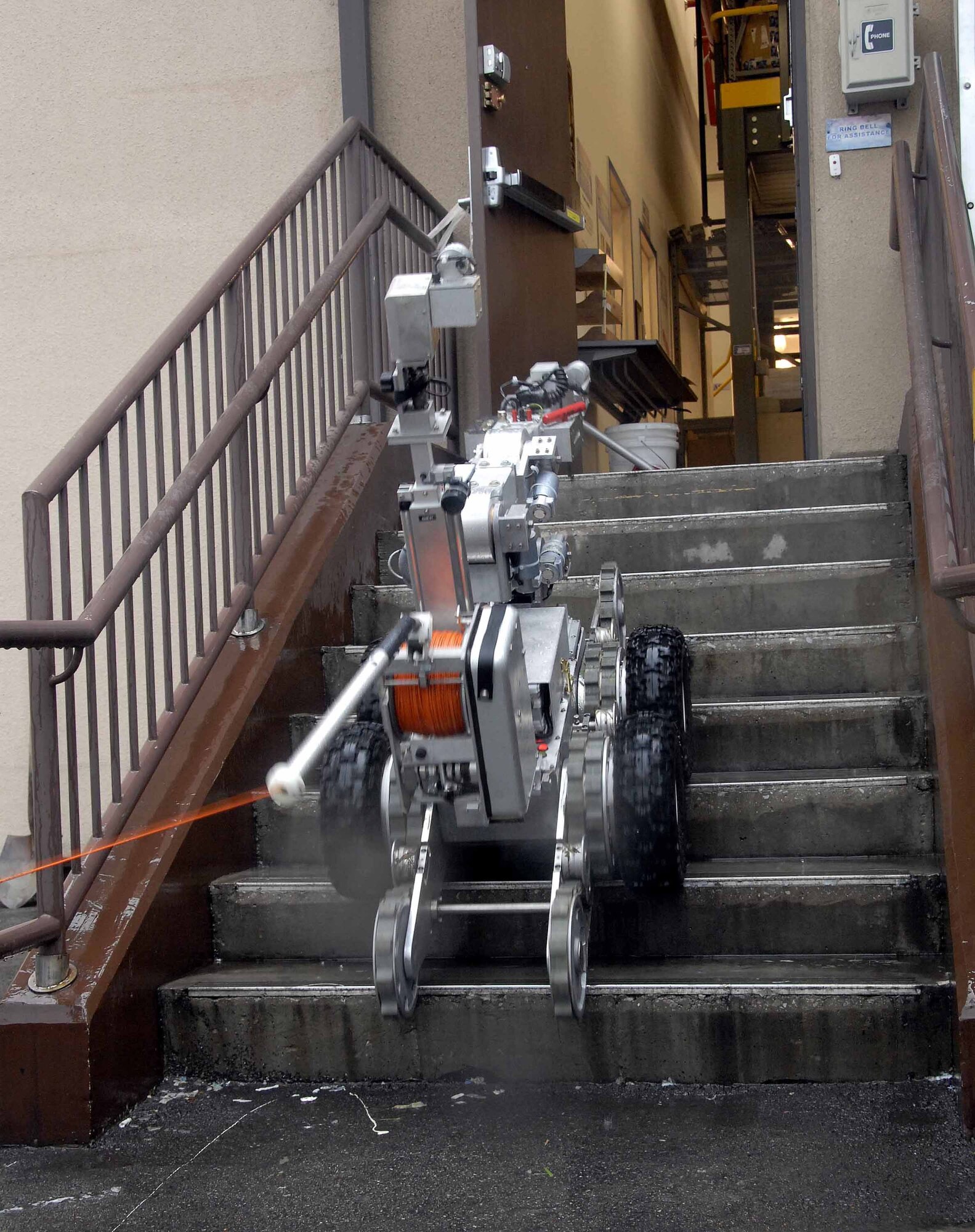 OSAN AIR BASE, Republic of Korea -- The F6A robot, used by the 51st Civil Engineer Squadron, Explosive Ordinance Disposal flight, prepares to remove a suspicious package from the base post office during a base-wide exercise here July 24. The F6A is equipped with several television cameras for remote viewing and a dexterous arm for hazardous tasks. (U.S. Air Force photo/Staff Sgt. Lakisha Croley)