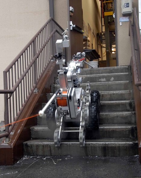 OSAN AIR BASE, Republic of Korea -- The F6A robot, used by the 51st Civil Engineer Squadron, Explosive Ordinance Disposal flight, prepares to remove a suspicious package from the base post office during a base-wide exercise here July 24. The F6A is equipped with several television cameras for remote viewing and a dexterous arm for hazardous tasks. (U.S. Air Force photo/Staff Sgt. Lakisha Croley)