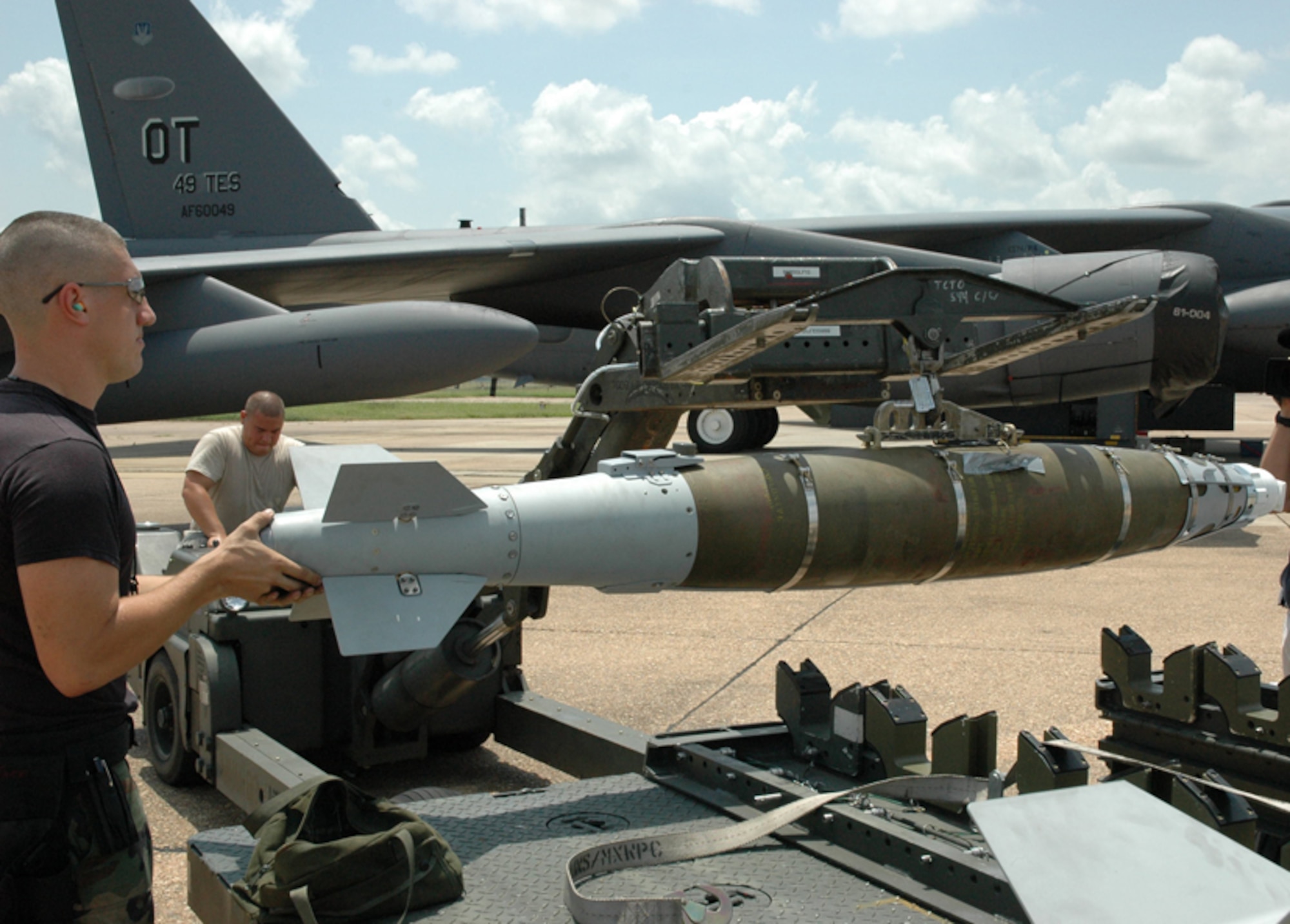 Staff Sgt. Jason Petry, 2nd Bomb Wing, begins moving a Laser Joint Direct Attack Munition to place it on a B-52 Stratofortress from the 49th Test and Evaluation Squadron at Barksdale Air Force Base, La., July 10. The 49th TES demonstrated the B-52's LJDAM capability on a target on the after a cross country flight. The target was stationary, but the 49th plans to demonstrate the LJDAM on a moving target soon. The laser piece of the munition allows for updated targeting and adjustments to moving targets. Photo by Boeing. 