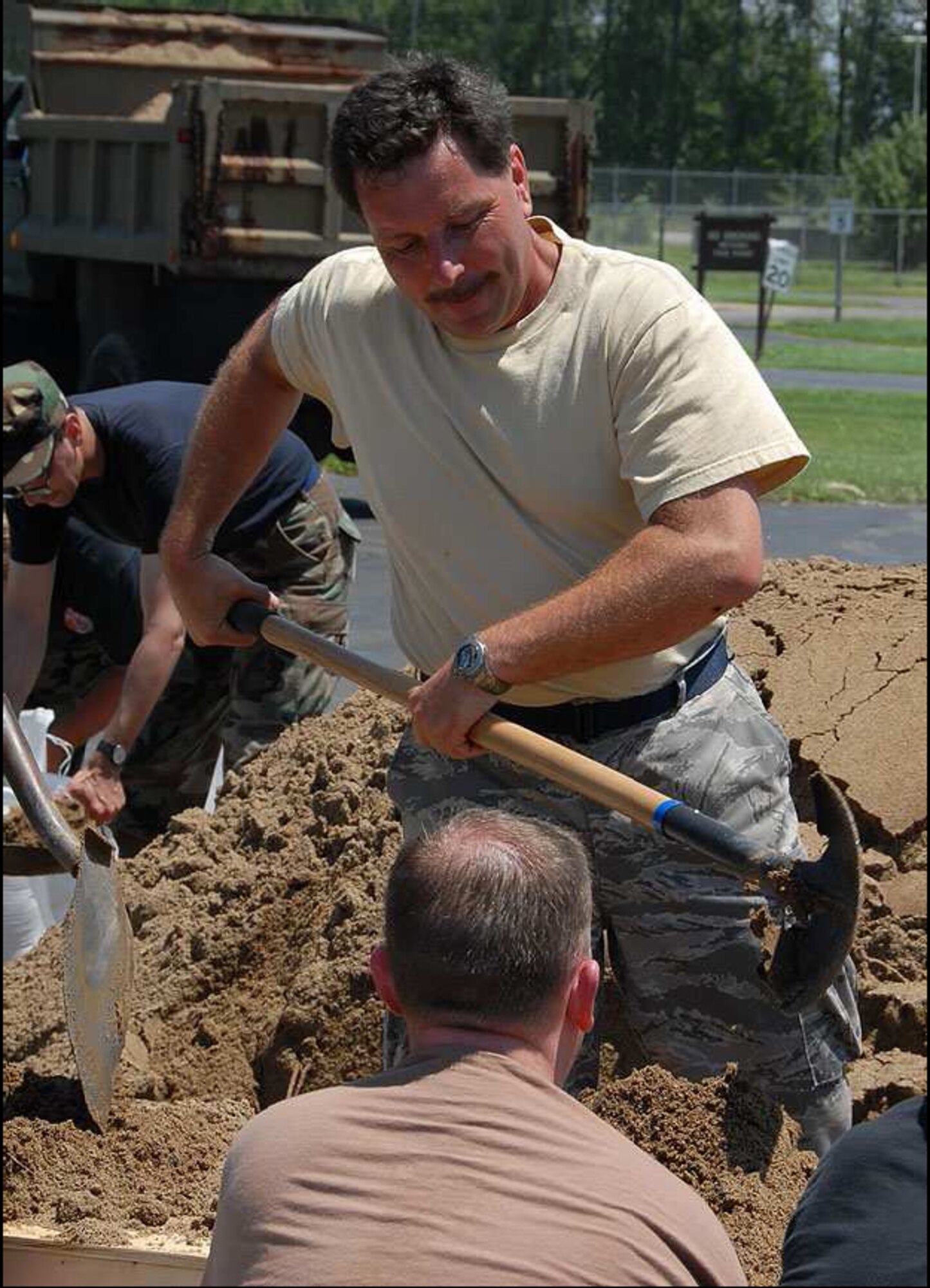 Indiana Air National Guard members continuously fill sandbags in relief following the flood waters that hit Vigo County June 7. The guardsmen are assigned to the 181st Intelligence Wing from Terre Haute, Ind. (photo by TSgt Michael W. Kellams) 