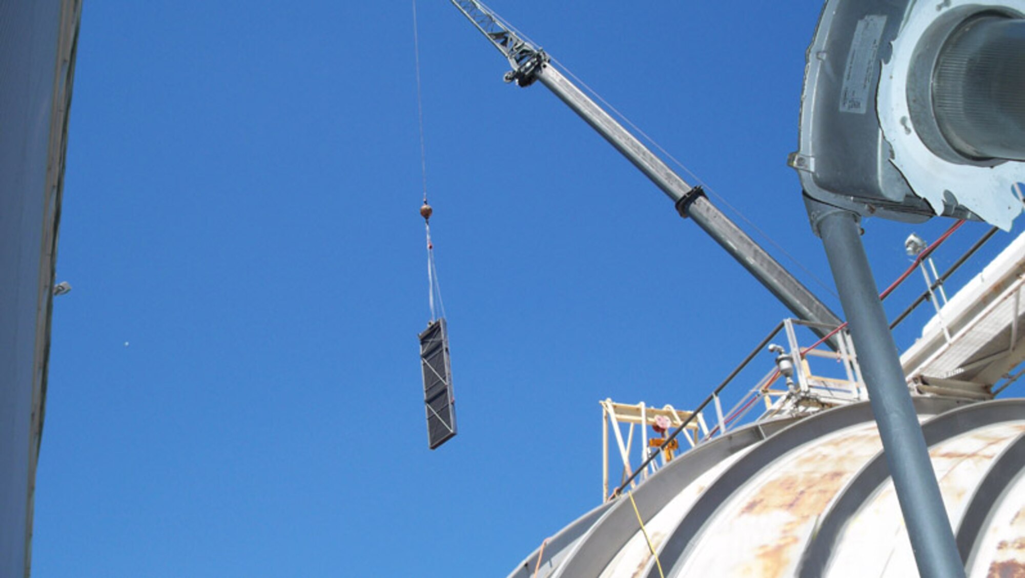 A crane operator lowers a cooling coil for installation into the RC1 Cooler during a major Engine Test Facility-focused maintenance and repair outage at Arnold Engineering Development Center. (Photo by Warner Holt)