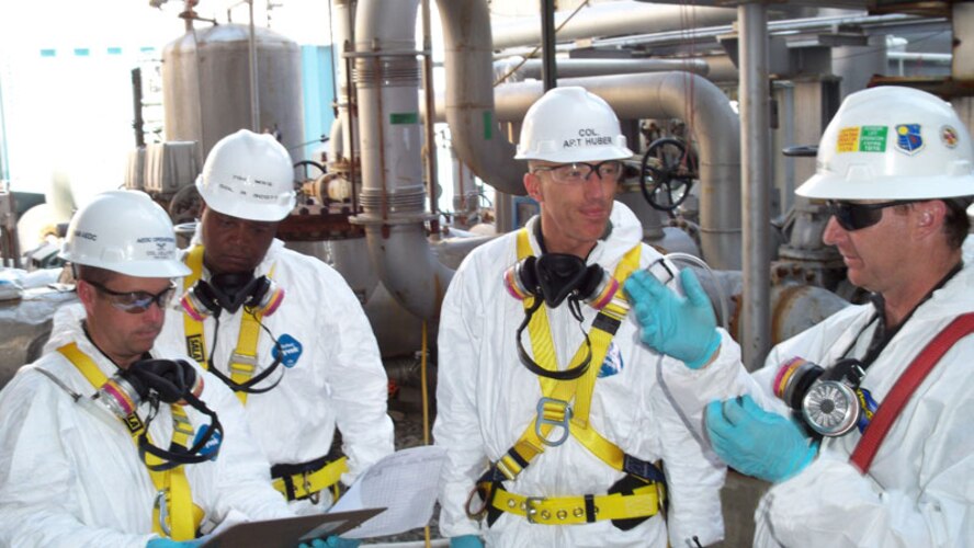 From right, Chris Jones, Aerospace Testing Alliance mechanical installation crew supervisor, briefs Arnold Engineering Development Center Commander Col. Art Huber on the RC1-Cooler repair and maintenance project as Col. Raytheon Scott, commander of 704th Maintenance Group and Col. James Jolliffe, 704th Test Group commander discuss the project. (Photo by Warner Holt)