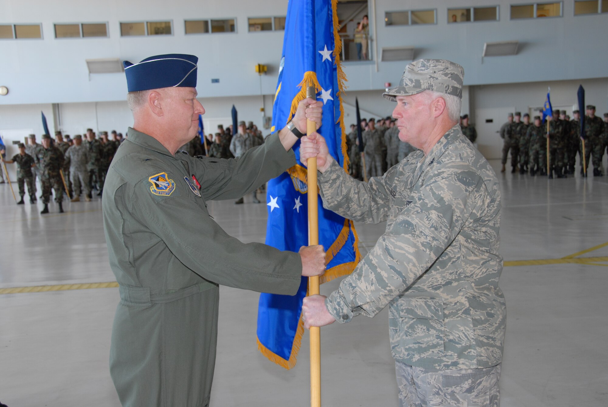 The 181st Fighter Wing, Terre Haute, Ind., conducted a redesignation ceremony on 13 July, 2008 officially marking its transition from flying jets to processing intelligence and providing ground support to air operations at forward locations. Brig. Gen. Richard Clevenger, Indiana Air national Guard Commander, presents Col. Jeffrey Hauser, Wing Commander, new unit flag. U.S. Air force photo by TSgt Michael W. Kellams.