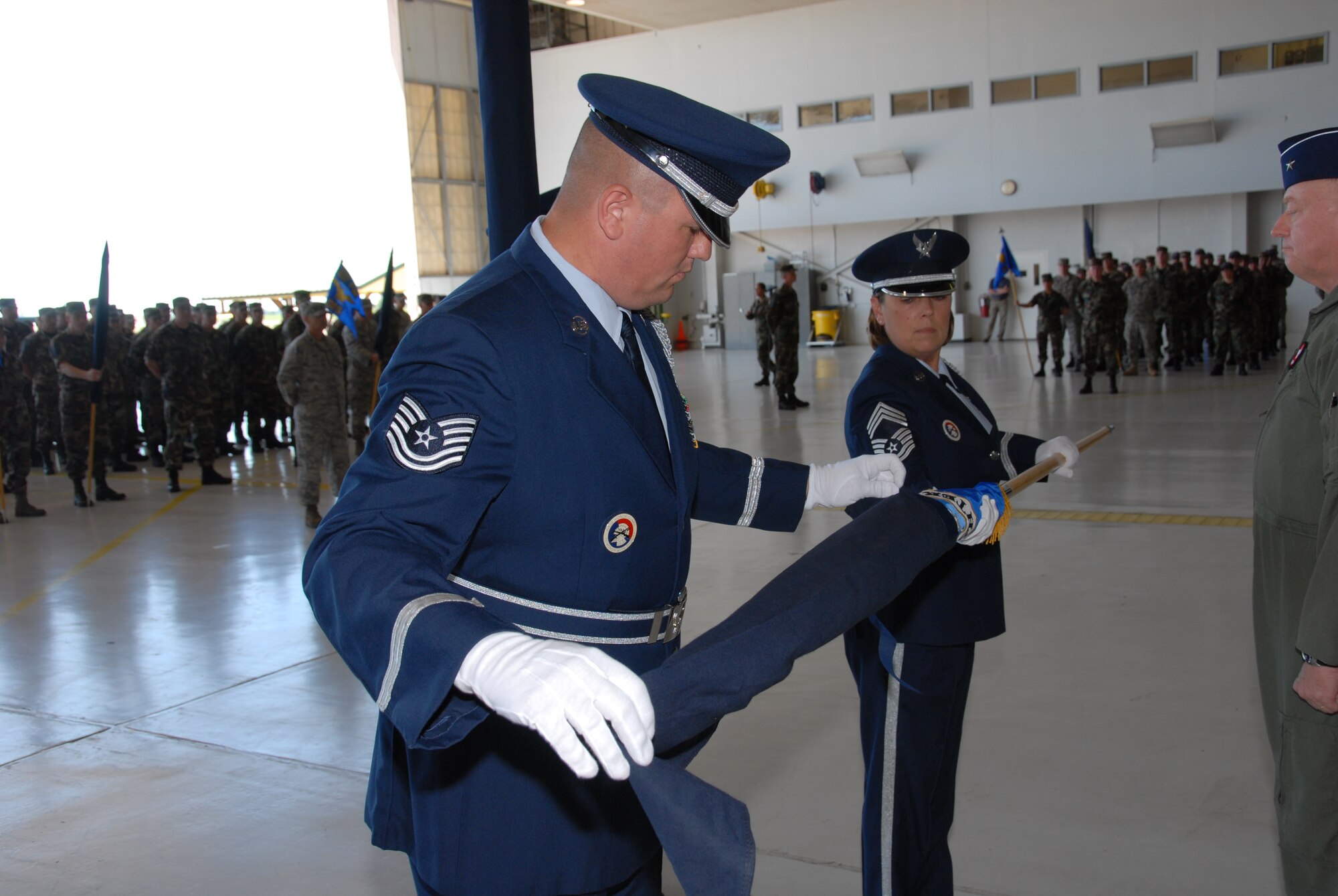 The 181st Fighter Wing, Terre Haute, Ind., conducted a redesignation ceremony on 13 July, 2008 officially marking its transition from flying jets to processing intelligence and providing ground support to air operations at forward locations. Honor guard members retire unit flag. U.S. Air force photo by TSgt Michael W. Kellams.