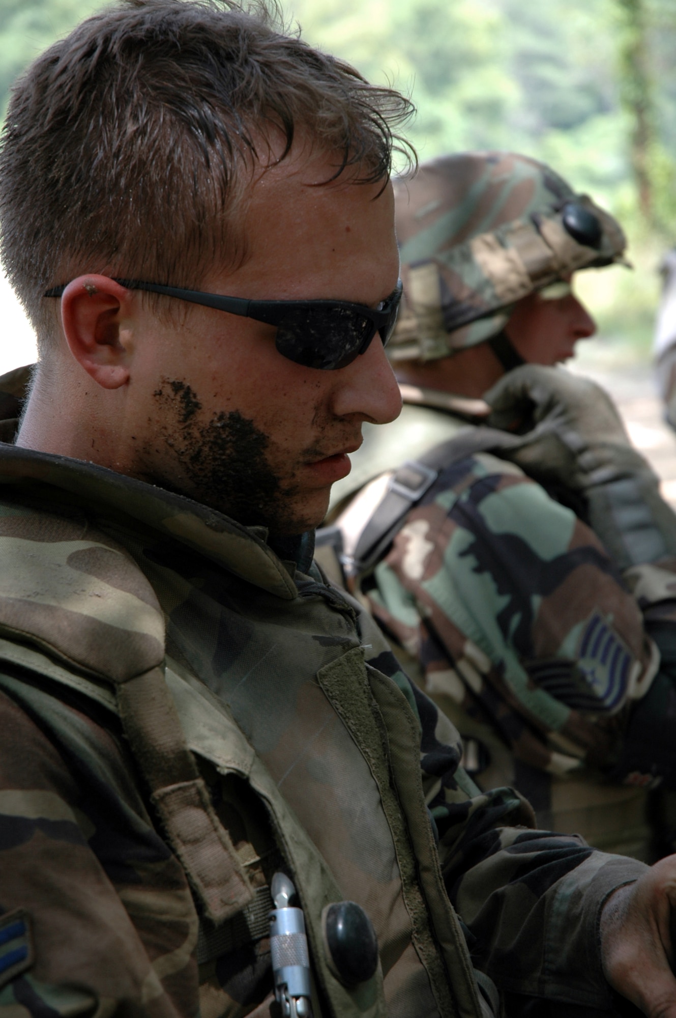 Students in the Advanced Contingency Skills Training Course 08-5 listen to feedback during combat first aid training on a Fort Dix, N.J., range July 17, 2008.  ACST, taught by the U.S. Air Force Expeditionary Center's 421st Combat Training Squadron, prepares Airmen for upcoming deployments.  (U.S. Air Force Photo/Staff Sgt. Paul R. Evans)
